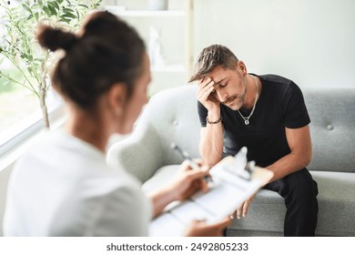 A Man with psychologist theraphy social problems concept drug addiction talk to a psychological woman - Powered by Shutterstock