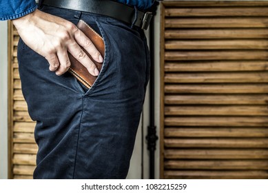 Man Pull The Wallet Out Of A Pant Pocket.