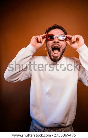 Man pulling up red sunglasses with surprised expression and open mouth