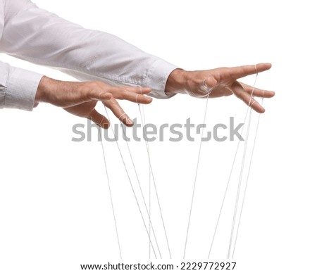 Man pulling strings of puppet on white background, closeup