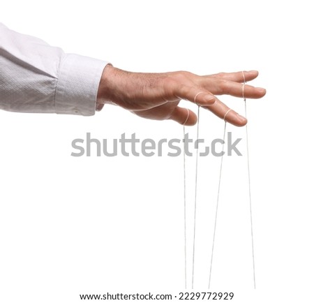 Man pulling strings of puppet on white background, closeup