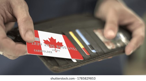 Man Pulls Plastic Bank Card With Flag Of Canada Out Of His Wallet, Fictional Card Number