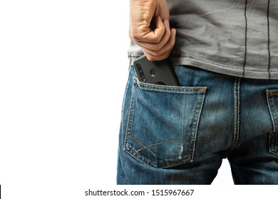 A man pulls a smartphone out of the back pocket of his jeans