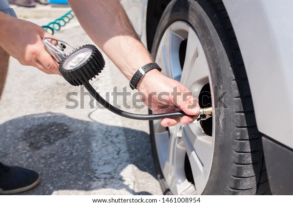 pumping air into car tires