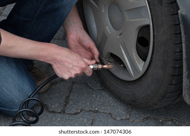 A man pumping a flat tyre