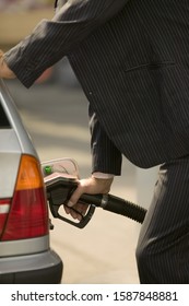 Man Pumping Gas Into Car