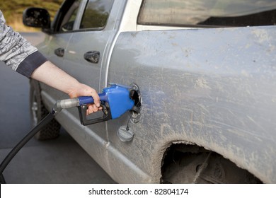 Man Pumping Gas Into A Pickup Truck