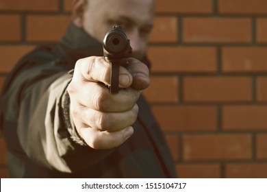 Man Punched The Gun Point Blank. The Hit Man Is Shooting. The Gun In The Hand Of A Bandit. Attempted Murder. Terrorism.