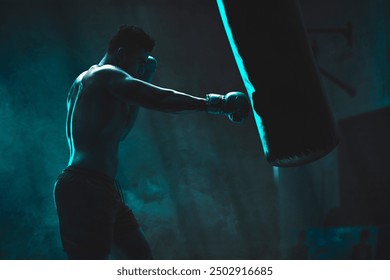 Man, punching bag and fight exercise at gym, training practice and attack challenge for fitness. Male person, neon and dojo club aesthetic for boxing competition, athlete and martial arts workout - Powered by Shutterstock