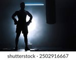 Man, punching bag and silhouette boxer at gym, training practice and attack challenge for combat. Male person, smoke and dojo club aesthetic for fight competition, athlete and martial arts workout