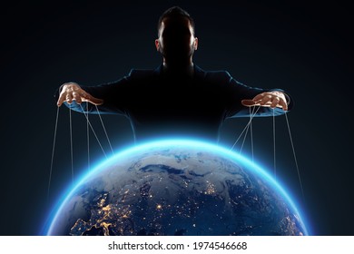 A Man, A Puppeteer, Manipulates The Planet. The Concept Of World Conspiracy, World Government, Manipulation, World Control