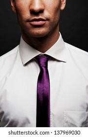 black suit and purple tie