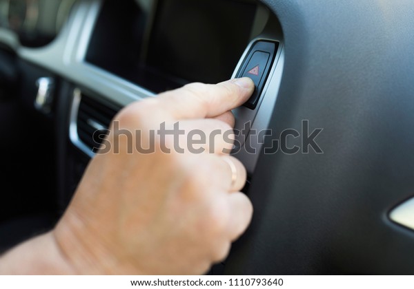 man pushes a button in the\
car