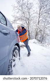 Man Pushing Car In Snow