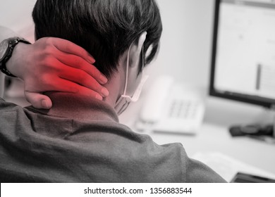 Man Put His Hand On The Back Of His Neck And Feeling Pain After Working With Computer For A Long Time. Office Syndrome. Herniated Disc.