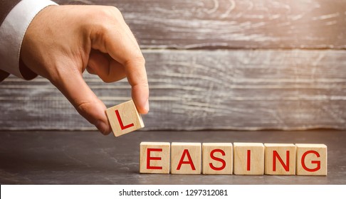 Man puts cubes with the word Leasing. A lease is a contractual arrangement calling for the lessee to pay the lessor for use of an asset. Property, buildings, vehicles are common assets that are leased