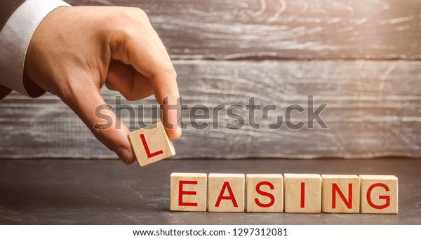 Man puts cubes with the word Leasing. A lease is a\
contractual arrangement calling for the lessee to pay the lessor\
for use of an asset. Property, buildings, vehicles are common\
assets that are leased