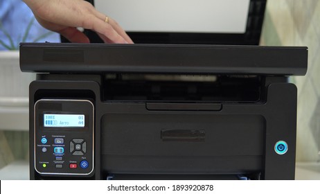 A Man Puts A Document On The Scanner To Scan And Tries To Start 4k
