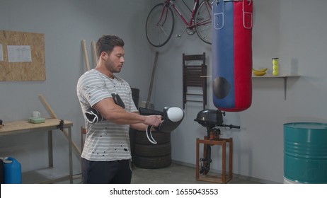 Man Puts On Boxing Gloves At The Gym