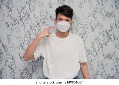 Man Puts On A Face Mask Elegant Man Wearing A Mouth Protection To Prevent Getting Sick At Work Or On The Way To Work  Isolated On White Background,pandemic And Social Distancing Concept.Covid-19