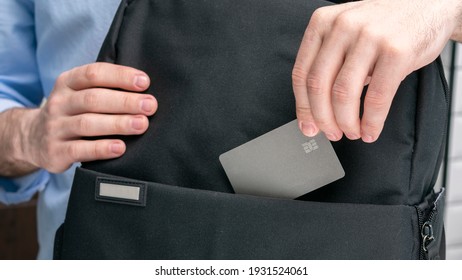 Man puts plastic card for payment in a backpack, male hands, cropped image, close-up - Shutterstock ID 1931524061