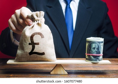 A Man Puts A Pound Sterling GBP Money Bag On The Scales Opposite To The Dollar. Exchange Rate, Comparison Of Economic Indicators. Investments In Foreign Currency Bonds. Avoiding Savings Inflation.