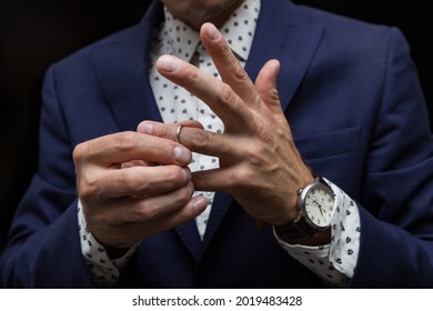 A Man Puts A Wedding Ring On His Finger, The Concept Of Cheating On A Married Man.