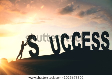 Man putting up abstract creative success word on sunlit sky background. Hard work and successful concept