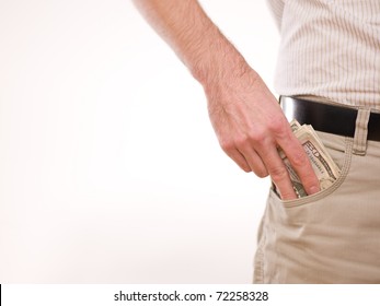 A Man Putting American Money In His Pants Pocket