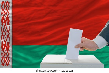 Man Putting Ballot In A Box During Elections In Belarus