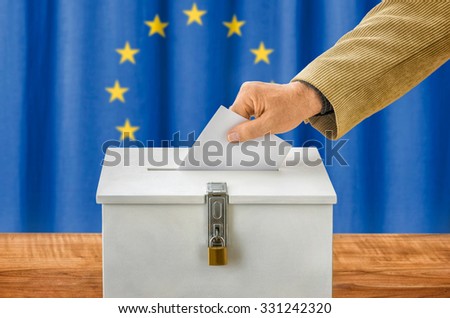 Man putting a ballot into a voting box - European Union