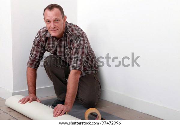 Man Putting Down Linoleum Flooring Stock Photo Edit Now 97472996