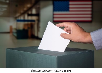 Man Putting Electoral Billuten In A Ballot Box During Elections In The Usa At A Polling Station