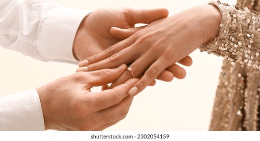 Man putting engagement ring on woman's finger, closeup - Shutterstock ID 2302054159