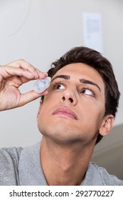 Man Putting Eye Drops