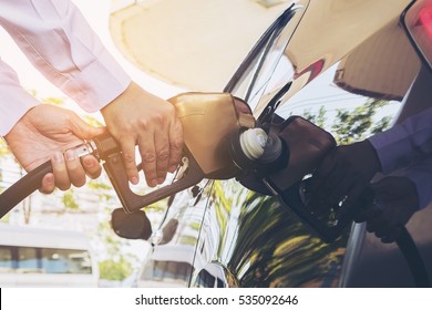 Man putting gasoline fuel into his car in a pump gas station - Shutterstock ID 535092646