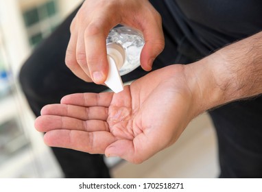 Man Putting Hand Sanitizer On His Hands