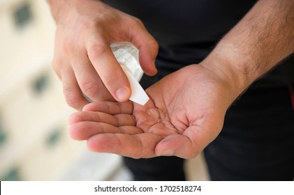 Man Putting Hand Sanitizer On His Hands