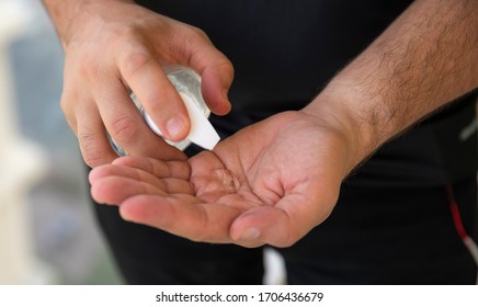 Man Putting Hand Sanitizer On His Hands