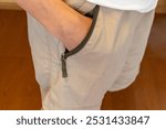 man putting his hand in his pants pocket