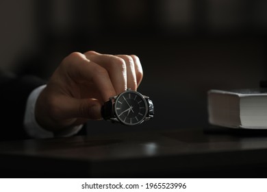 Man Putting Luxury Wrist Watch On Table, Closeup. Space For Text