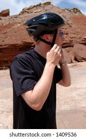 Man Putting On Bike Helmet