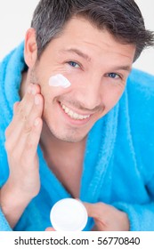 Man Putting On Cream Lotion On Face