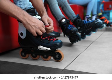 Man putting on roller skates indoors, closeup - Shutterstock ID 1427993477