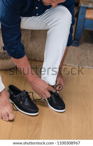 man putting on shoes