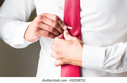 Man Putting On Tie Clip, Closeup