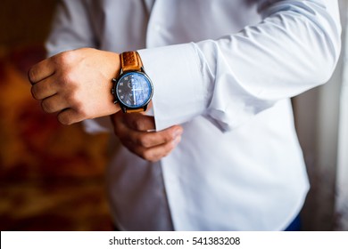 A Man Putting On Watch