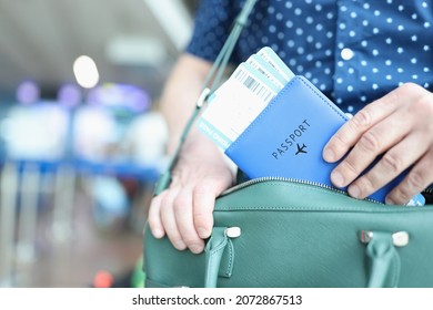 Man Putting Passport With Plane Tickets In Laptop Bag Closeup