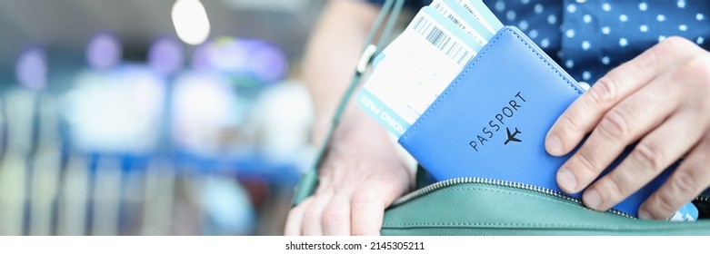 Man Putting Passport With Plane Tickets In Laptop Bag Closeup