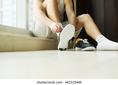 Man Putting Running Shoes On.